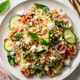 Un plat coloré de quinoa avec ricotta, épinards et oignons rouges.